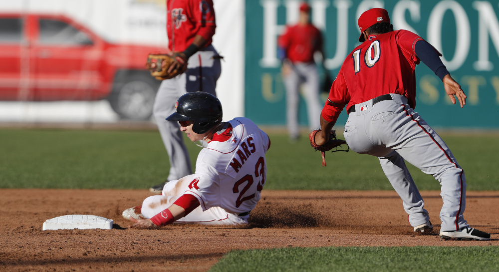 Danny Mars of the Portland Sea Dogs slides past Osvaldo Abreu of the Harrisburg Senators and into second base Saturday night during the second inning of Portland's 6-5 setback at Hadlock Field.
