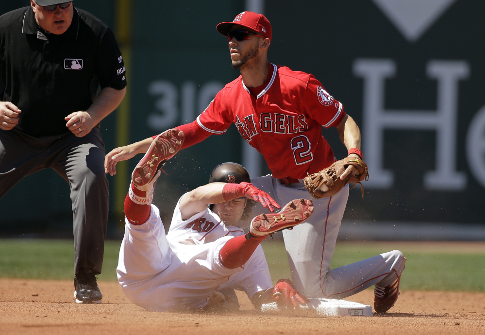 Andrew Benintendi is tagged out by Angels shortstop Andrelton Simmons as he tries to stretch a single into a double in the fourth inning Sunday.