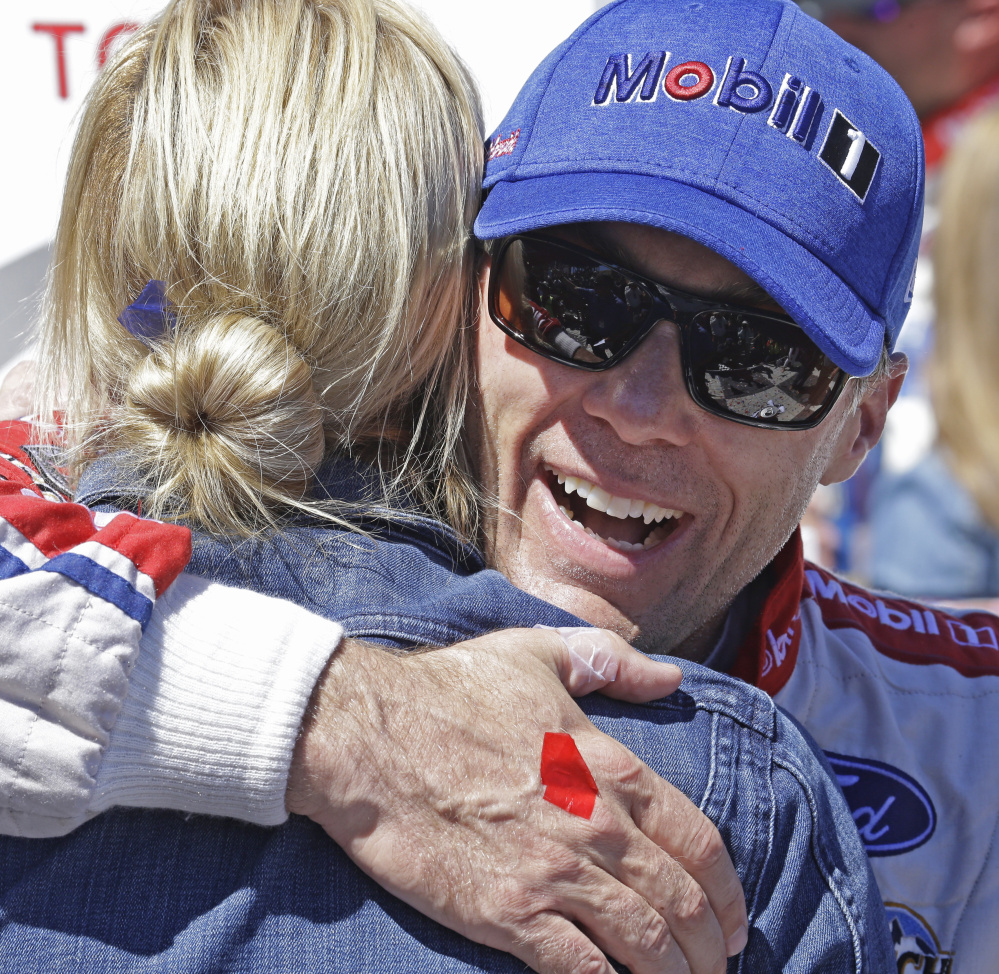 Kevin Harvick embraces his wife, DeLana, after his road course victory Sunday in Sonoma, Calif.