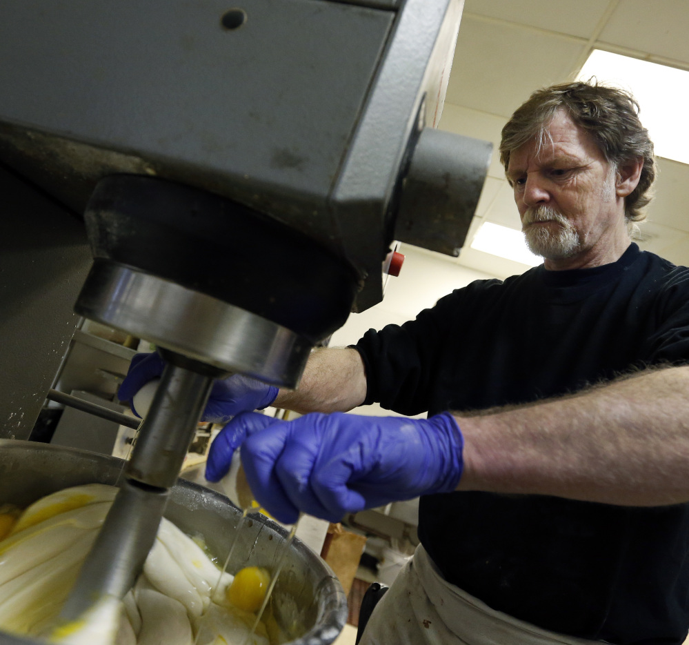 Masterpiece Cakeshop owner Jack Phillips cracks eggs into a cake batter mixer in his store in Lakewood, Colo. He refused to make a wedding cake for a gay couple.