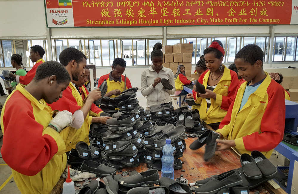In this Thursday, Jan. 5, 2017, photo, Ethiopian factory workers sort shoes at the Chinese company Huajian's plant in Addis Ababa, Ethiopia. Workers from at Ganzhou Huajian International Shoe City Co., a southeastern China factory used by Ivanka Trump and other fashion brands, say they've faced long hours, low pay and verbal abuse. Huajian, meanwhile, has been moving production to Ethiopia, where workers make around $100 a month, a fraction of what they pay in China, according to Song Yiping, a manager at Huajian's Ethiopian factory, who spoke to the Associated Press in January. (AP Photo/Elias Meseret)
