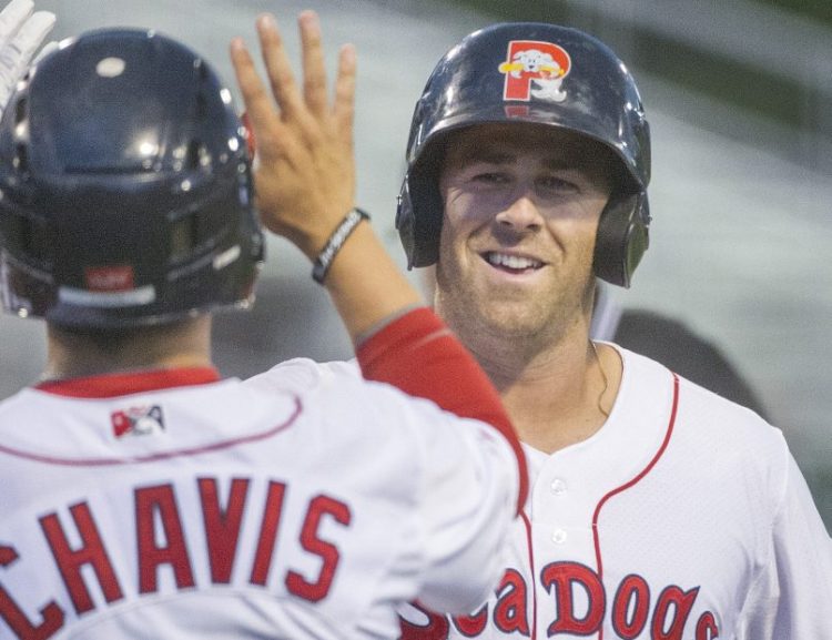 Mike Olt of the Portland Sea Dogs is met by teammate Michael Chavis after hitting a two-run homer Tuesday night. The Sea Dogs beat the New Hampshire Fisher Cats 2-1 when rain ended the game in the sixth inning.
