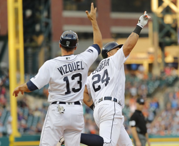 Miguel Cabrera of the Tigers, right, celebrates his three-run home run against the Royals with first-base coach Omar Vizquel during the third inning of Detroit's 5-3 win at home Tuesday.