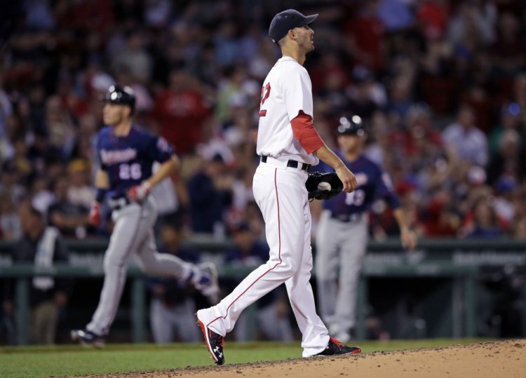 Red Sox starting pitcher Rick Porcello walks back to the mound as Minnesota's Max Kepler rounds the bases on his two-run home run in the sixth inning Wednesday night at Fenway Park.