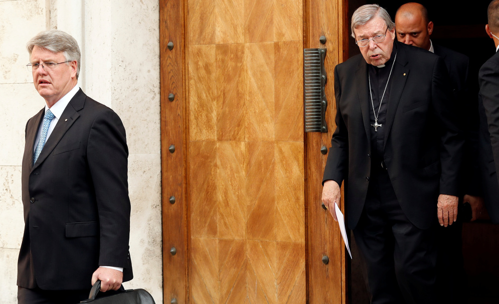 Cardinal George Pell leaves his house in Rome Thursday. One of the most powerful officials in the Vatican, he said he would return to his native Australia to fight the assault charges.