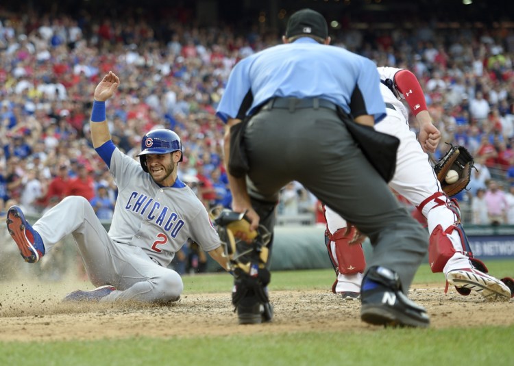 Tommy La Stella of the Chicago Cubs slides home to score on Jon Jay's two-run double in the ninth inning of the 5-4 comeback victory Thursday against the Washington Nationals.