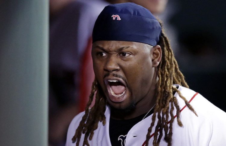 Boston designated hitter Hanley Ramirez roars as he walks through the dugout after his solo home run against the Minnesota Twins in the sixth inning Thursday night at Fenway Park.