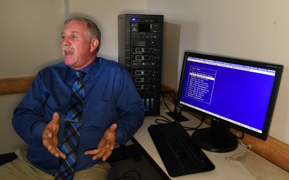 University of Maine at Augusta cybersecurity program director Henry Felch diplays the Forensic Recovery of Evidence Device in the new cybersecurity lab.
