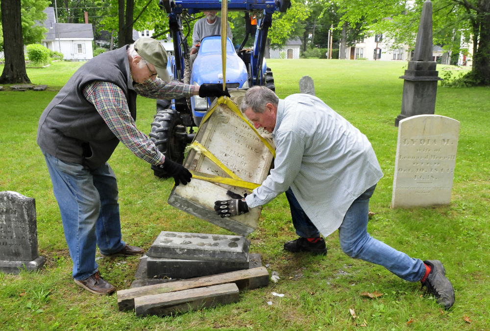 The headstone of Samuel and Sally Jewett is re-erected Tuesday at their grave in the churchyard at the former site of St. Anne's Church in Gardiner. 