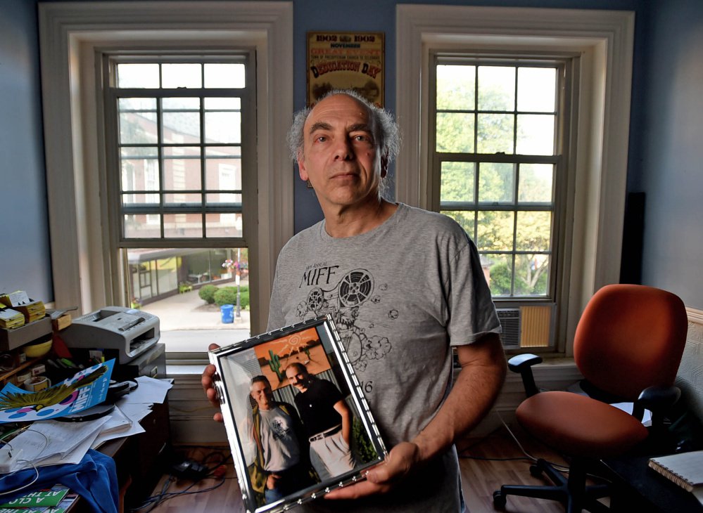 Maine International Film Festival programmer Ken Eisen poses Friday with a portrait of him and director Jonathan Demme in his MIFF office on Main Street in Waterville. Demme will be honored at the 20th annual Maine International Film Festival.