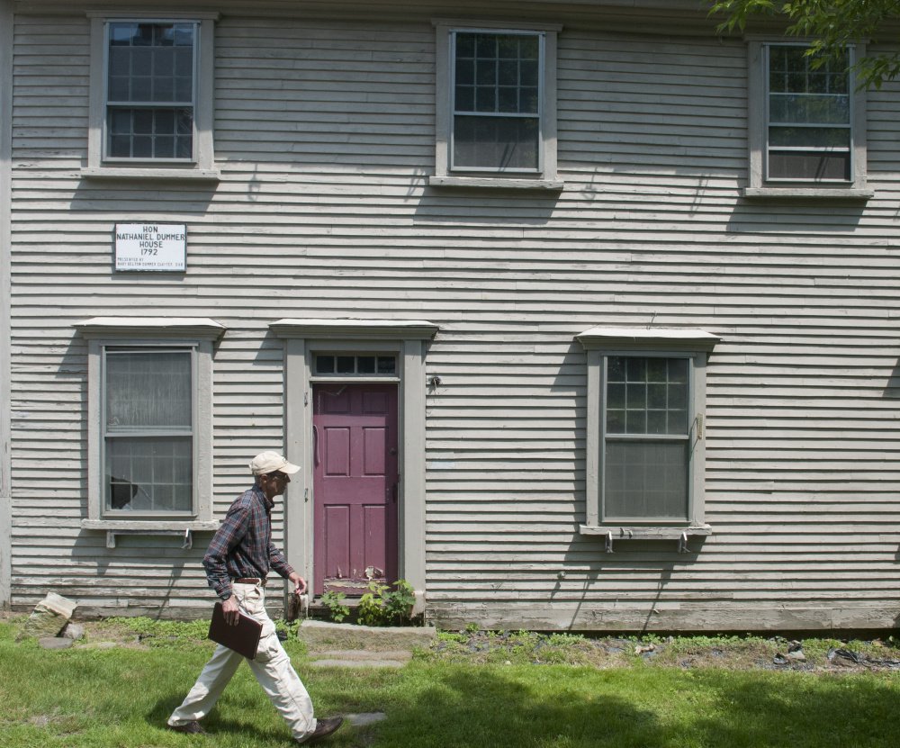 Staff photo by Joe Phelan
Hallowell city historian Sam Webber walks past the Dummer House Friday during an interview about the city's plans to move the historic home to make way for more parking in downtown Hallowell during the reconstruction of Water Street.