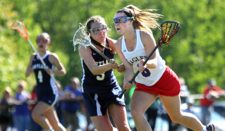 Messalonskee's Lauren Pickett moves the ball up field past Portland's Elena Clifford during the first half a Class A girls' lacrosse quarterfinal Wednesday at Thomas College in Waterville.
