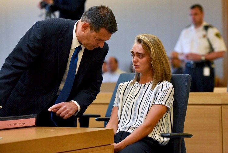 Attorney Joseph Cataldo talks to his client, Michelle Carter, at Taunton Juvenile Court in Taunton, Mass., on Monday. Carter is charged with manslaughter for sending her boyfriend text messages encouraging him to kill himself.
