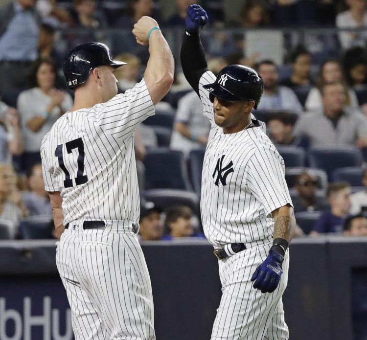 Matt Holliday, left, celebrates with Aaron Hicks after Hicks hit a home run during the sixth inning Friday night in New York.