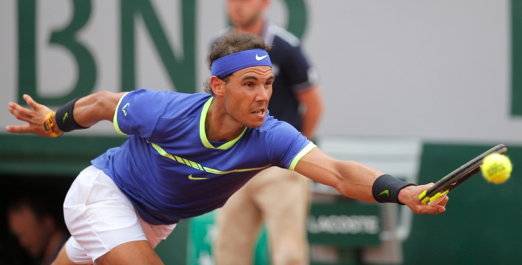 Spain's Rafael Nadal stretches to return the ball to Switzerland's Stan Wawrinka during their final match of the French Open at the Roland Garros stadium on Sunday in Paris. 