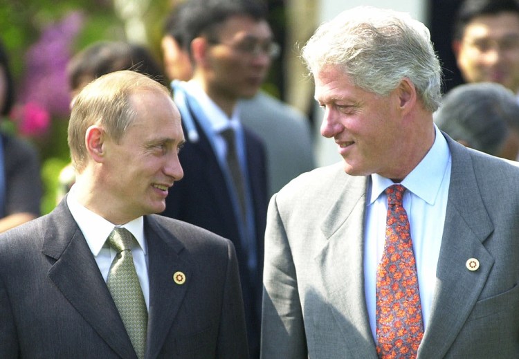 President Bill Clinton and President Vladimir Putin chat before a G8 meeting in Japan on  July 21, 2000. 