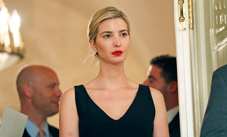 Ivanka Trump, the daughter and assistant to President Trump, stands in the doorway as her father speaks before signing bills in the Diplomatic Reception Room at the White House, in Washington. 