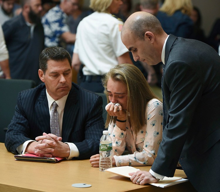 Michelle Carter cries while flanked by defense attorneys Joseph Cataldo, left, and Cory Madera, after being found guilty of involuntary manslaughter on Friday.