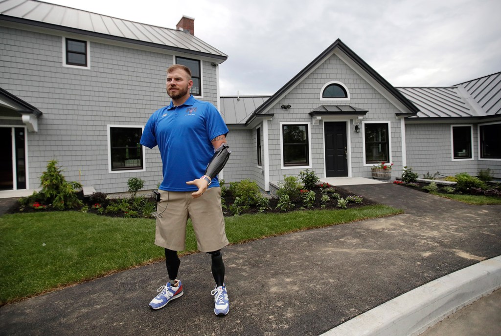 Travis Mills gives a tour of his camp for wounded veterans on June 15. The retreat will host a total of 88 veterans and their families in its first year.