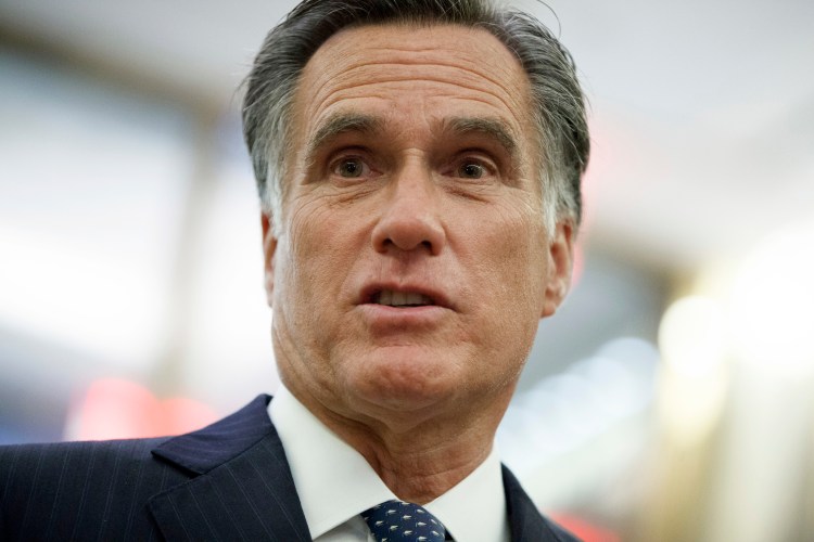 Mitt Romney talks with reporters in New York on Nov. 29, 2016. 