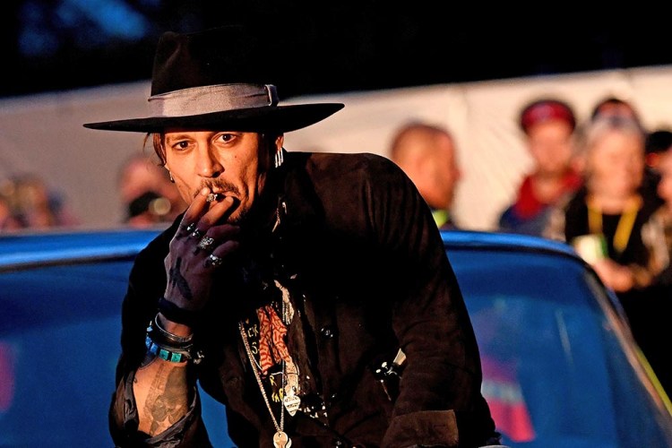 Johnny Depp poses on a Cadillac before presenting his film "The Libertine," at Cinemageddon during the Glastonbury Festival in Britain, on Thursday.