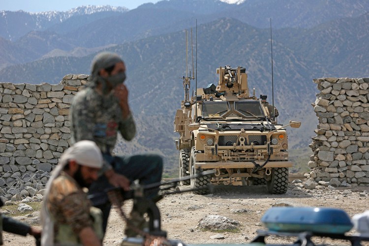 U.S. forces and Afghan security police patrol  near the site of a U.S. bombing in the Achin district of Jalalabad, east of Kabul, on April 17, 2017. The bulk of the additional U.S. troops will train and advise Afghan forces, according a Pentagon official.