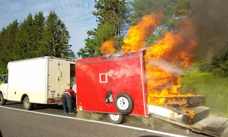 A mover's 8-foot utility trailer full of furniture and clothes caught on fire around 7 a.m. and was destroyed along with a stretch of pavement on Interstate 95 and a Department of Transportation sign. While the cause is undetermined, the fire appears to have started in the axle.