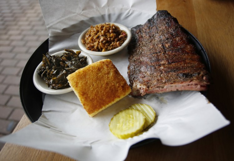 A half-rack of ribs with collards, cornbread, rice and beans at Elsmere in South Portland. 