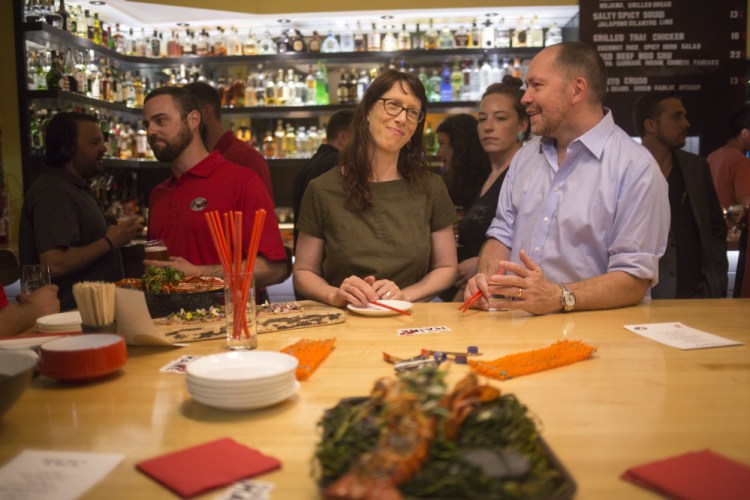 From left, lobsterman Dave Laliberte, San Francisco restaurateur Nicole Krasinski, and Chicago chef Giuseppe Tentori attend the "Maine After Midnight" event hosted by the Maine Lobster Marketing Collaborative at The Honey Paw last month in Portland. The event allows networking opportunities meant to promote the placement of new-shell lobsters on menus far and wide.
