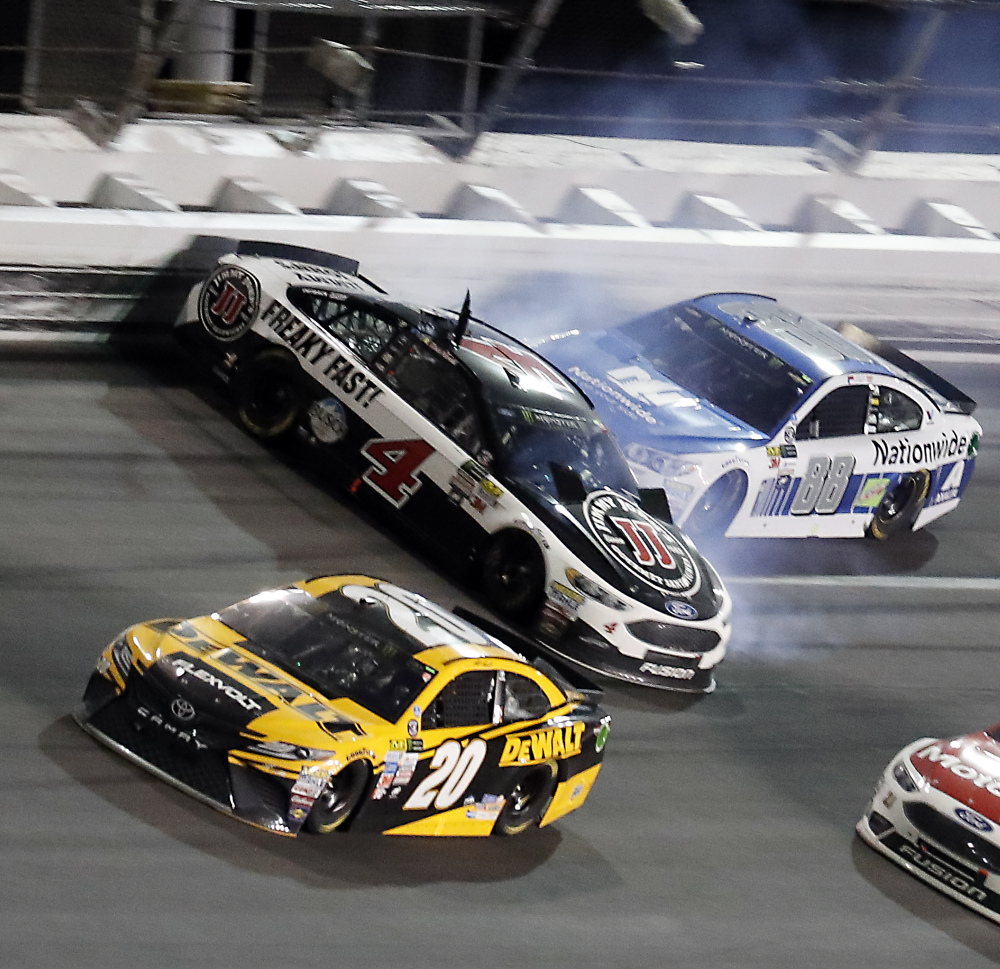 Kevin Harvick (4) is hit by Dale Earnhardt Jr. (88) after he cut a tire as Matt Kenseth (20) avoids the crash during the NASCAR Cup auto race at Daytona International Speedway on Saturday in Daytona Beach, Fla.
