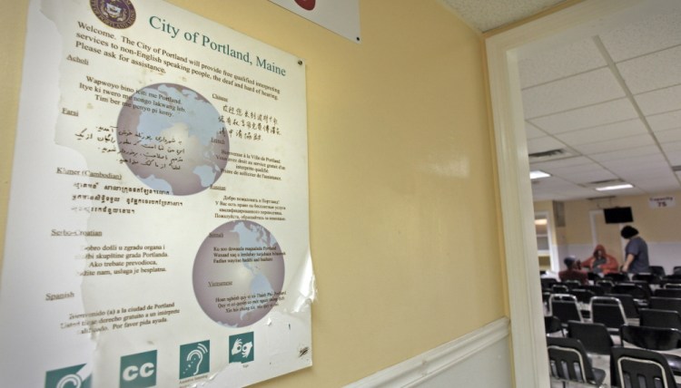 A multilingual sign posted in the General Assistance office in Portland offers staff assistance to non-English speakers in 2014. At the time, a surge of asylum seekers from Central African countries was putting a strain on municipal aid programs.