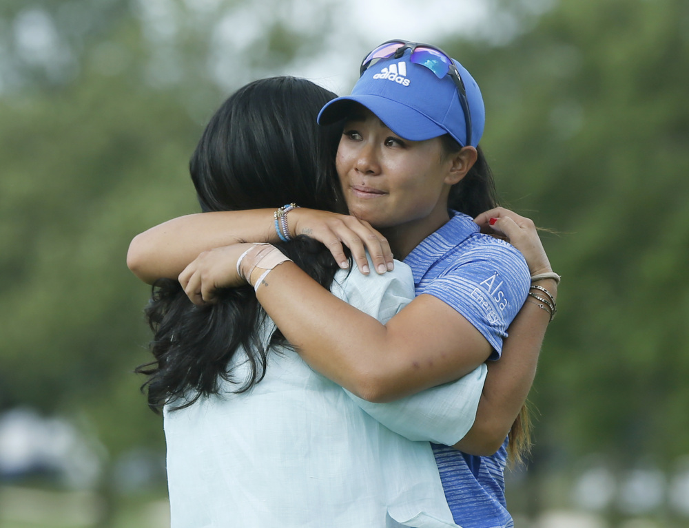 Danielle Kang, right, is hugged by her mom, Grace Lee, after Kang won the Women's PGA Championship on Sunday at Olympia Fields Country Club in Olympia Fields, Ill.