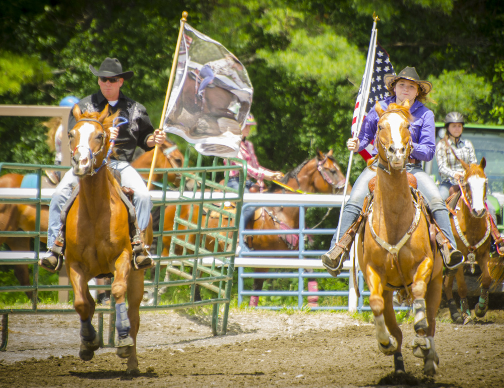 Hardy Cummings, left, and Harmony Renaud lead the start of the Halee Lyn Cummings Memorial Barrel Race. Cummings started the event to honor his late daughter.
