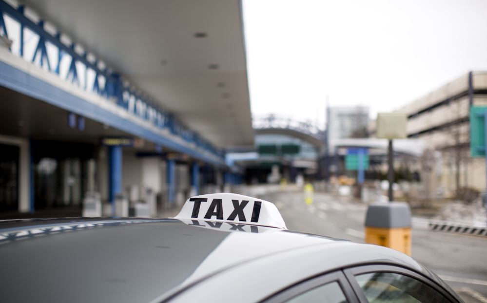 The growing popularity of doing work on the side using the digital "platform economy" has helped Uber hire 1 million drivers, and the local ones compete with taxi cab companies for fares outside the Portland International Jetport, above.