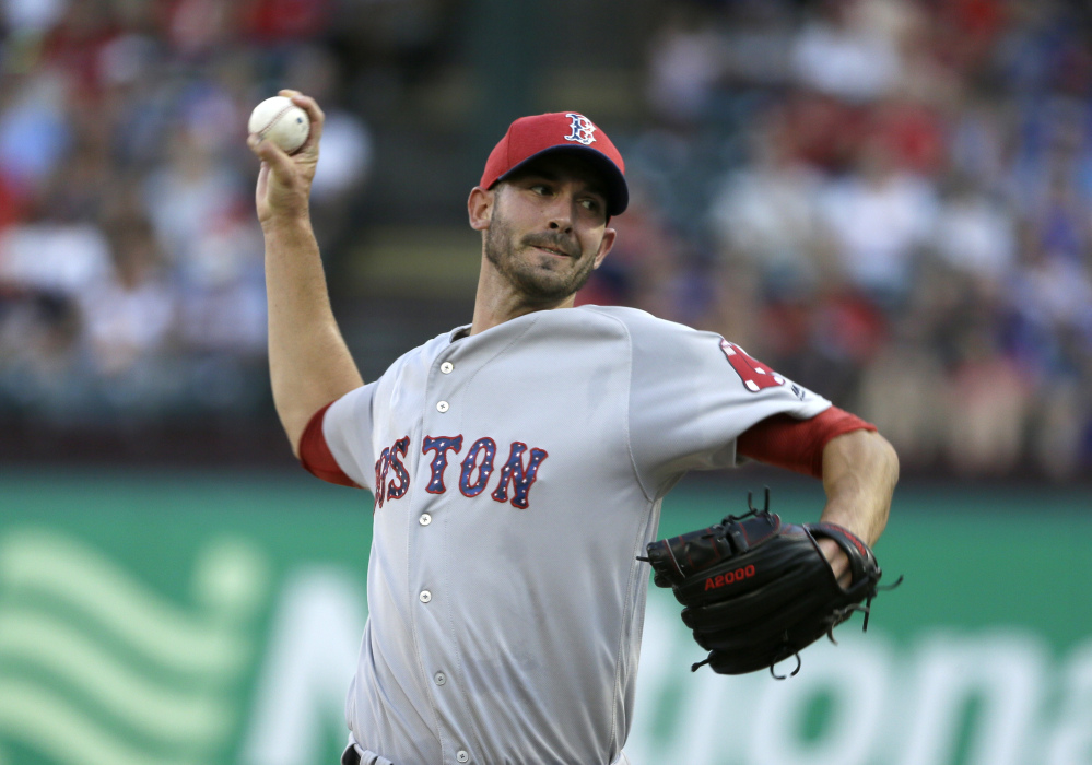 Red Sox starter Rick Porcello throws in the first inning. He pitched into the seventh inning but didn't get a decision as the game went 11 innings.