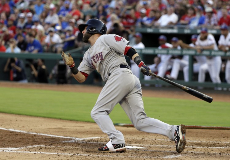 Dustin Pedroia hits a two-run single in the second inning of a July 4, 2017, game against the Texas Rangers. Pedroia drove in four runs in the game.