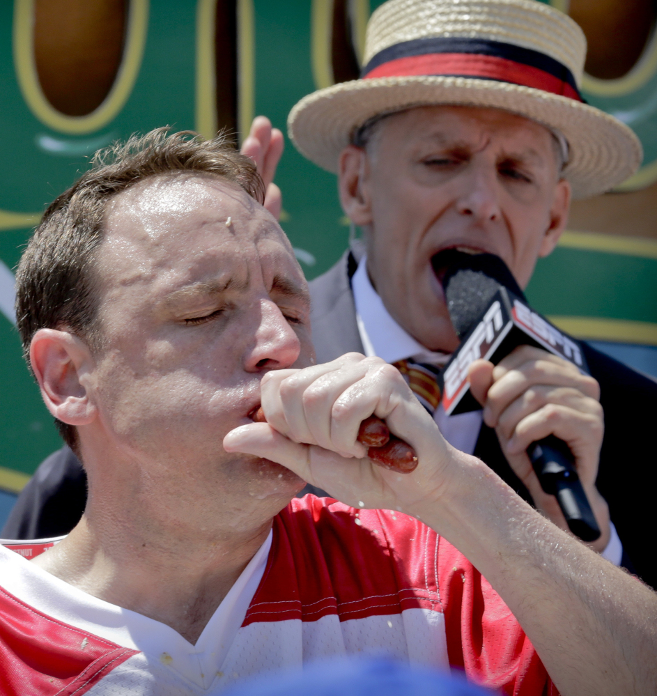 Joey "Jaws" Chestnut chomps his way to win Nathan's hot dog eating contest again Tuesday in New York.
