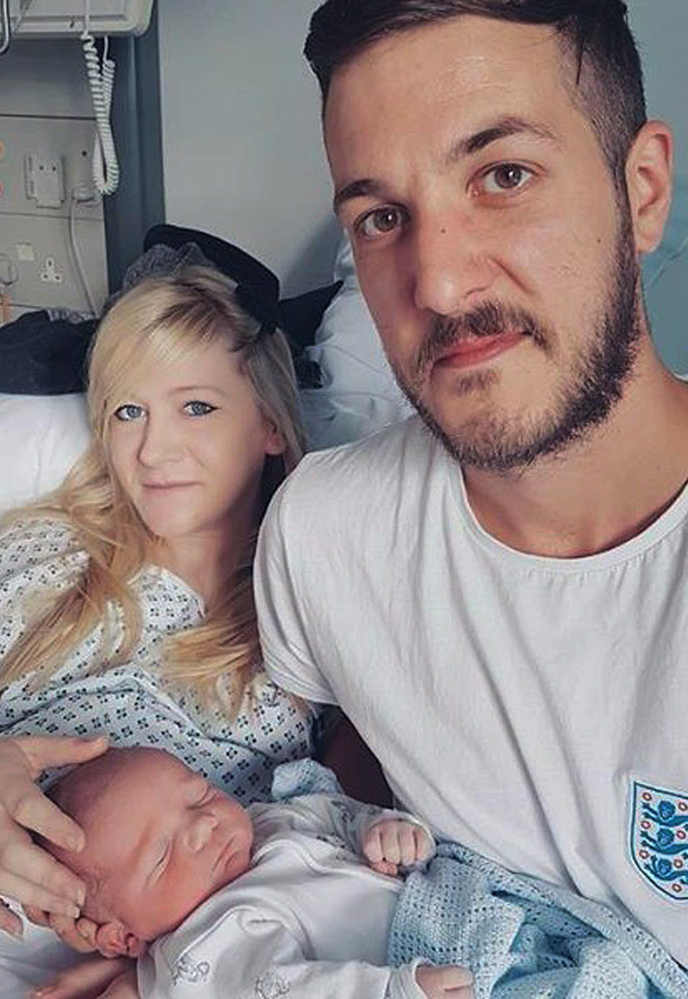 Chris Gard and Connie Yates hold their son Charlie Gard at Great Ormond Street Hospital, in London.