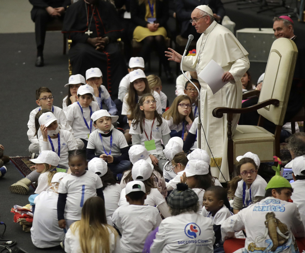 Pope Francis is surrounded by children as he speaks with patients and caregivers from the Vatican's Bambino Gesu Pediatric Hospital last December. A Vatican-commissioned report in 2014 spotlighted breaches of accepted medical practices.