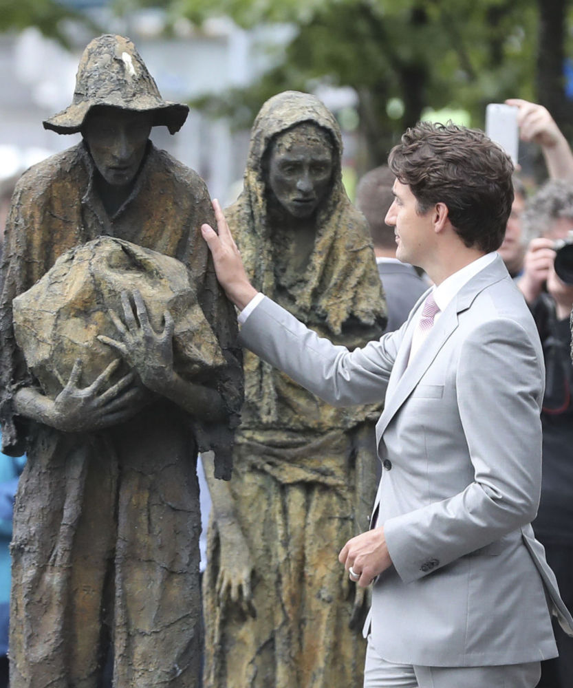 Canadian Prime Minister Justin Trudeau views the Famine Memorial statues Tuesday in Dublin, Ireland. An online petition has been started to chastise Trudeau for his government's apparent plan to pay millions to the alleged killer of a U.S. soldier in Afghanistan.