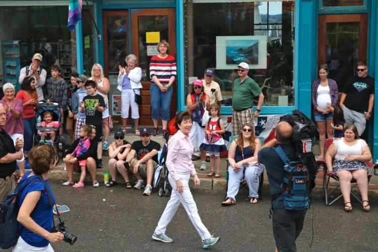 Sen. Susan Collins, R-Maine, marches in Eastport's parade Tuesday. "There was only one issue," she said, of her constituents' focus on health care. 