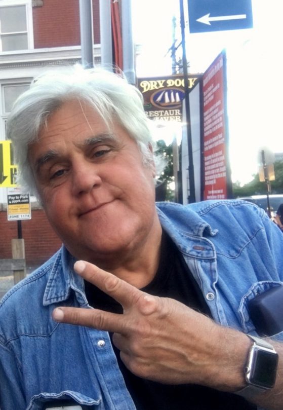 Comedian and car buff Jay Leno poses Tuesday for a picture on Commercial Street in Portland.