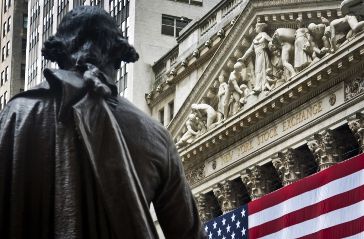 A statue of George Washington stands at Federal Hall near the flag-covered pillars of the New York Stock Exchange, in New York. Trading was subdued after the U.S. Independence Day holiday and ahead of the summit of the Group of 20 industrial nations later in the week.