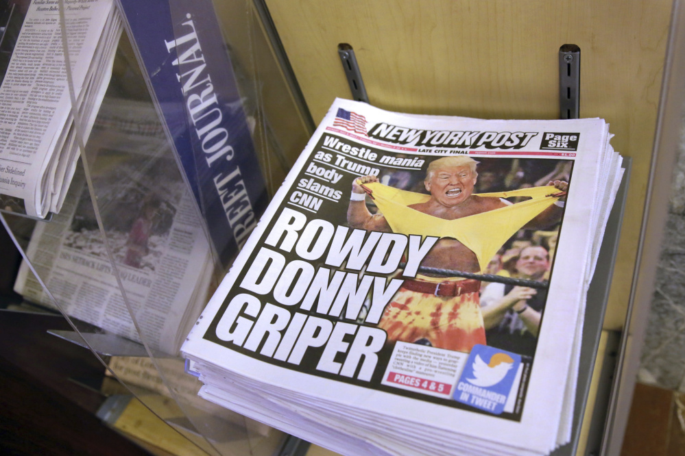 Copies of the New York Post with an illustration of President  Trump as a professional wrestler on the front page are displayed Monday at a newsstand in New York City.
