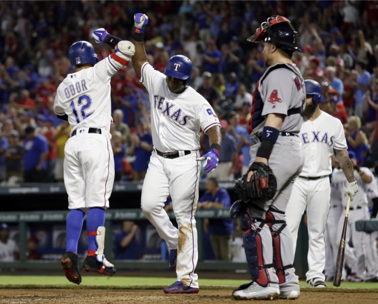 The Rangers' Rougned Odor (12) and Adrian Beltre celebrate Odor's two-run home run that scored Beltre in the second inning of what became a romp for the Rangers.