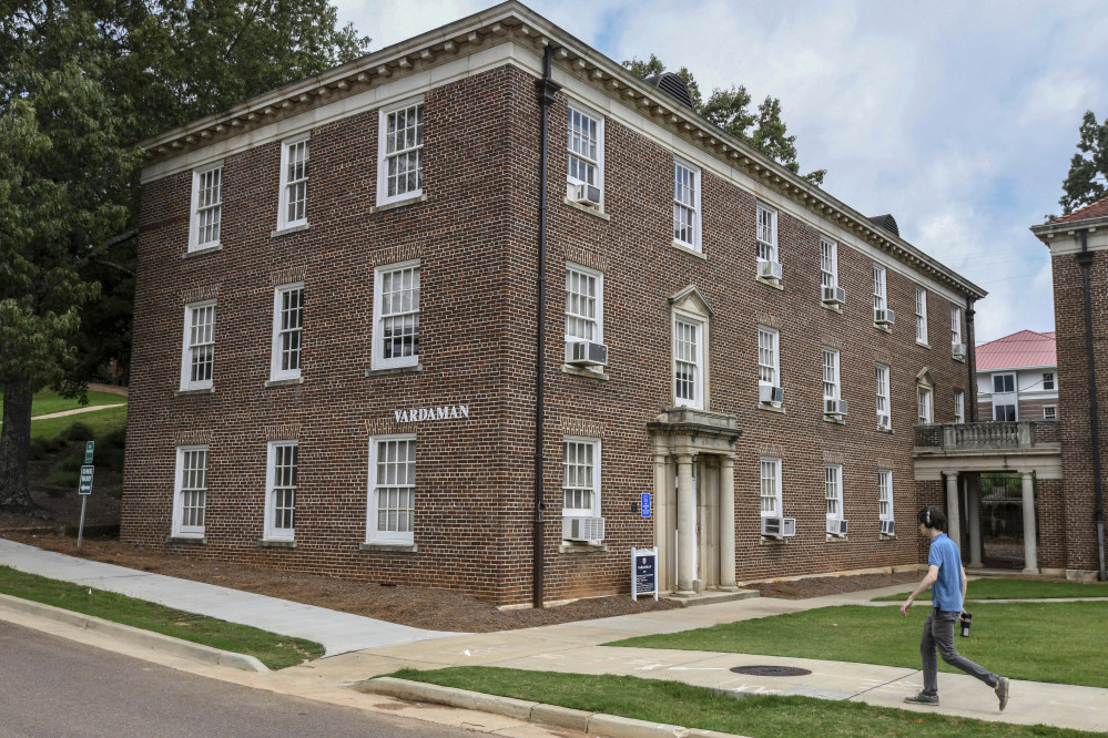 A pedestrian walks past Vardaman Hall at the University of Mississippi in Oxford on Thursday. The school says it will post a sign acknowledging that slaves built some structures on the main campus founded before the Civil War.