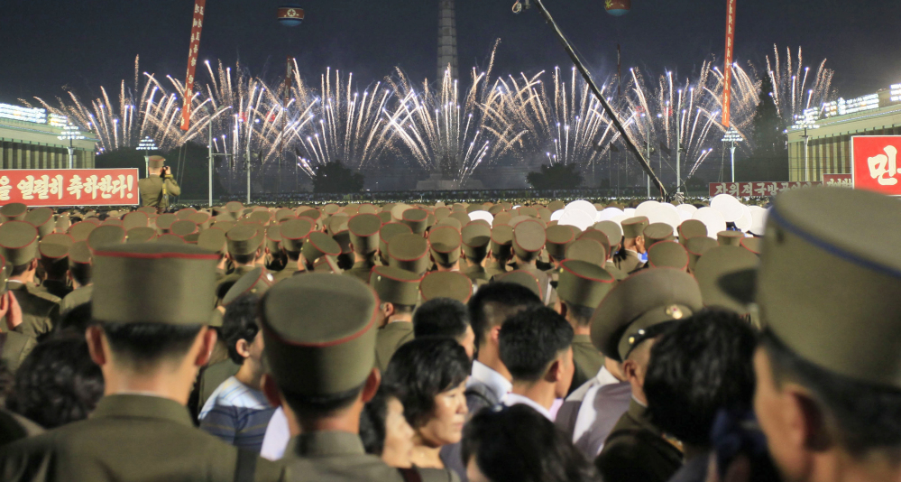 Soldiers and civilians watch fireworks in Kim Il Sung Square in Pyongyang, North Korea, on Thursday, as they celebrate the successful test launch of North Korea's first intercontinental ballistic missile two days earlier.
