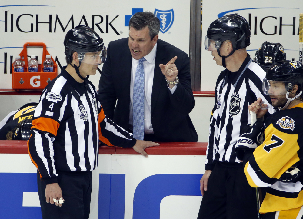Wes McCauley of South Portland, left, listening to Pittsburgh Penguins Coach Mike Sullivan, was one of the four referees selected to work the Stanley Cup finals this year. Highly respected, he's been involved in the past five finals.