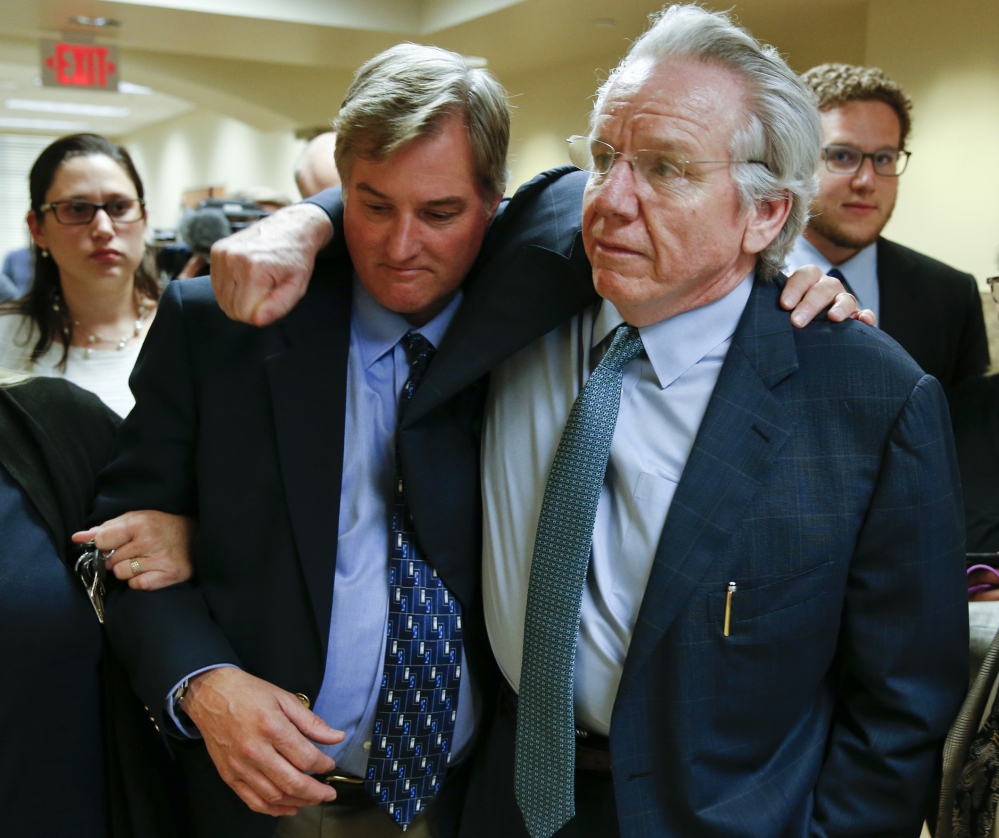 Shannon Kepler, left, a former police officer, celebrates with his attorney, Richard O'Carroll, after a third mistrial was announced Friday in Tulsa, Okla., in Kepler's fatal shooting of his daughter's black boyfriend.