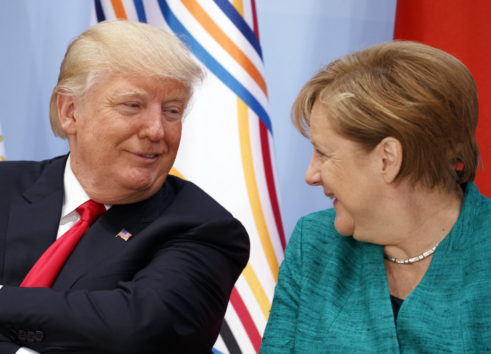 President Trump called German Chancellor Angela Merkel "incredible" in Hamburg, Germany, on Saturday. "I deplore this," Merkel said of the U.S. leaving the climate agreement.